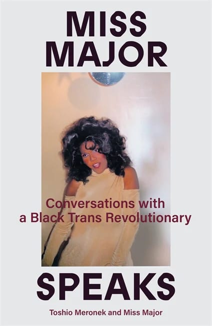 The cover of Miss Major Speaks: Conversations with a Black Trans Revolutionary, which features an old photo of Miss Major dancing and posing cute in a sparkly gold dress and striking makeup, the bottom of a disco ball above her